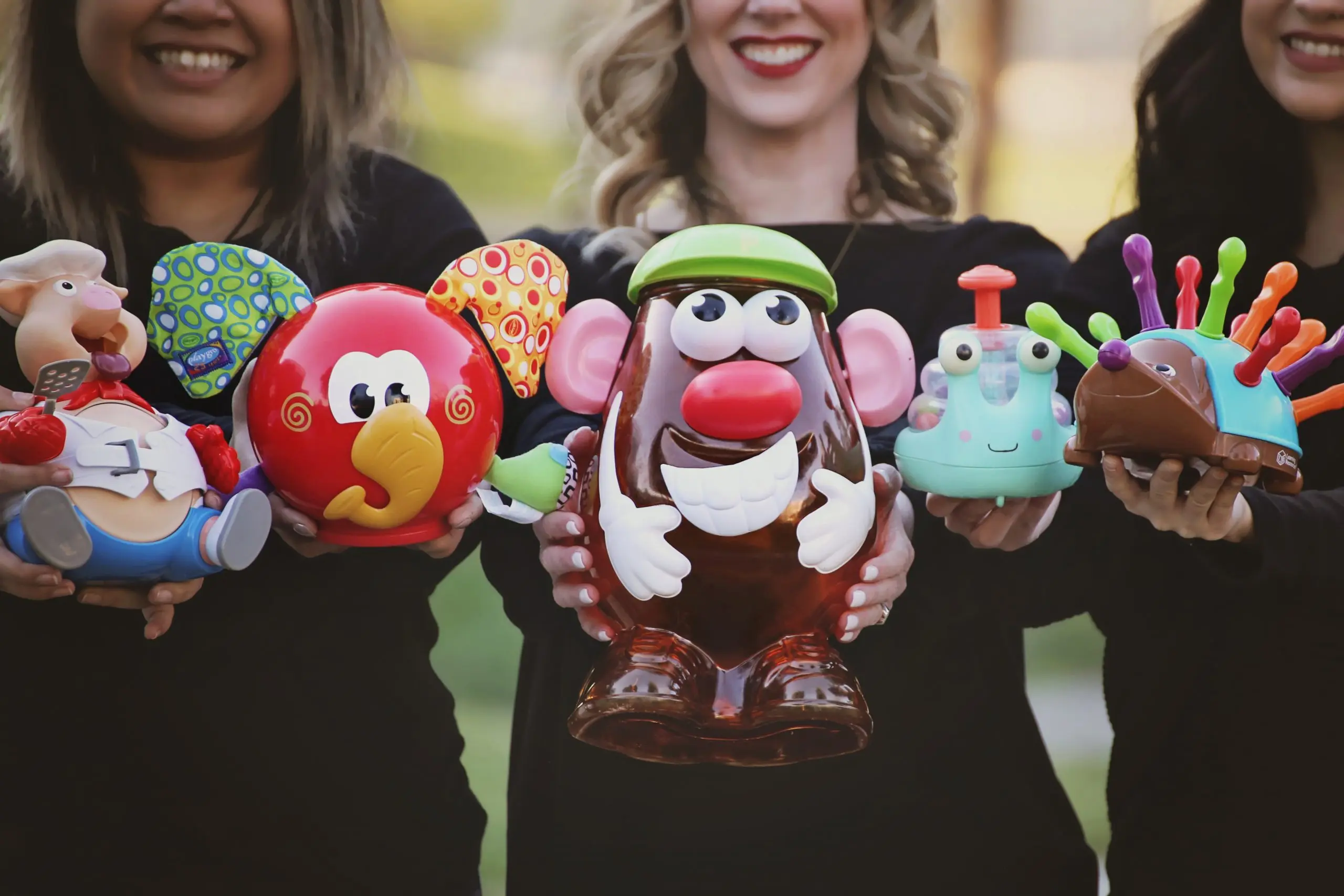 Metamorphosis Therapy Group Staff Holding Children's Toys